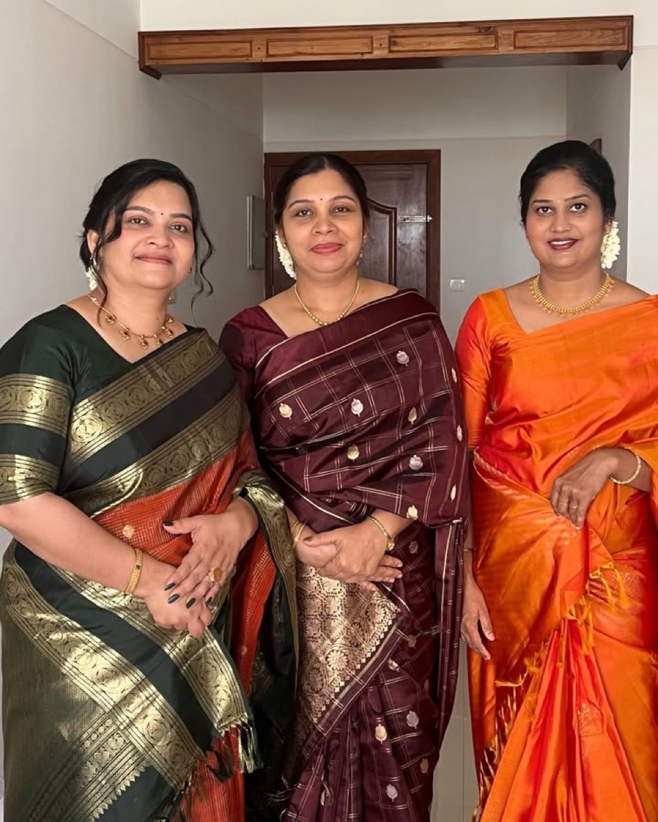 Three women in silk sarees at a family function