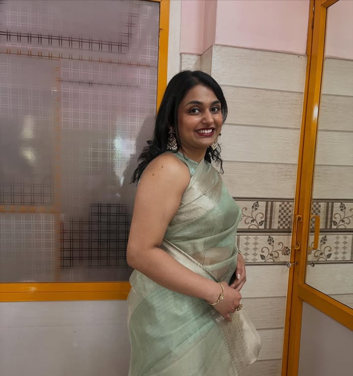 A client in a mint green saree