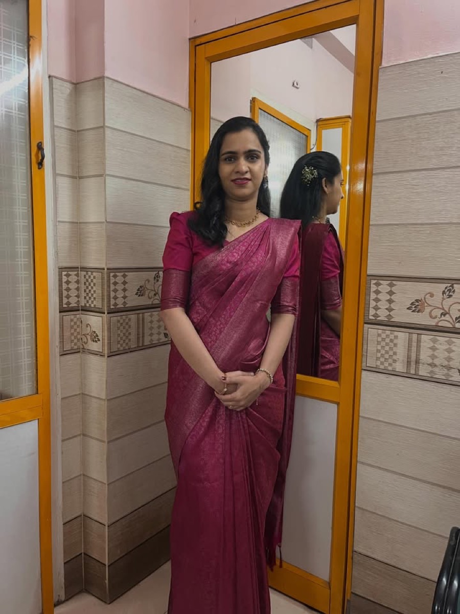 A client in a magenta saree