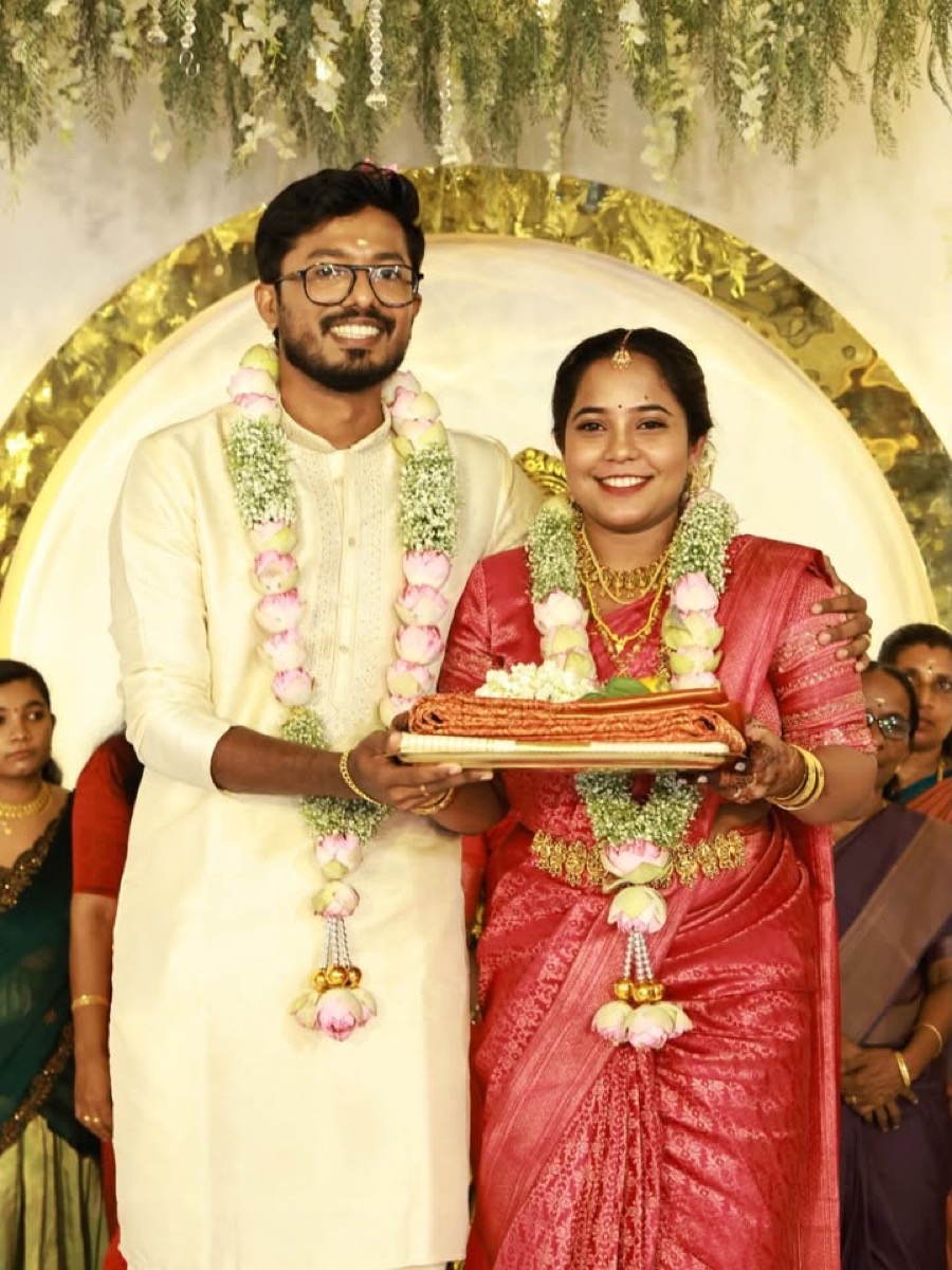 A bride and groom with jasmine garlands on the wedding stage