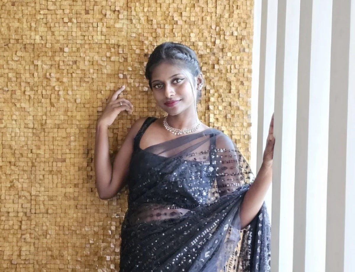 A client in a textured black saree