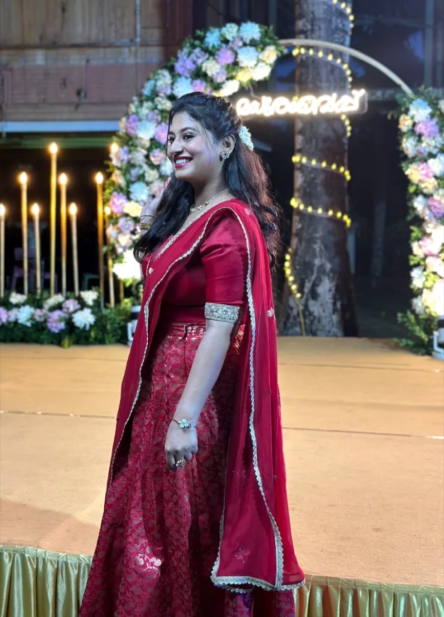 A client in a red outfit with a half-up hairstyle at an evening event