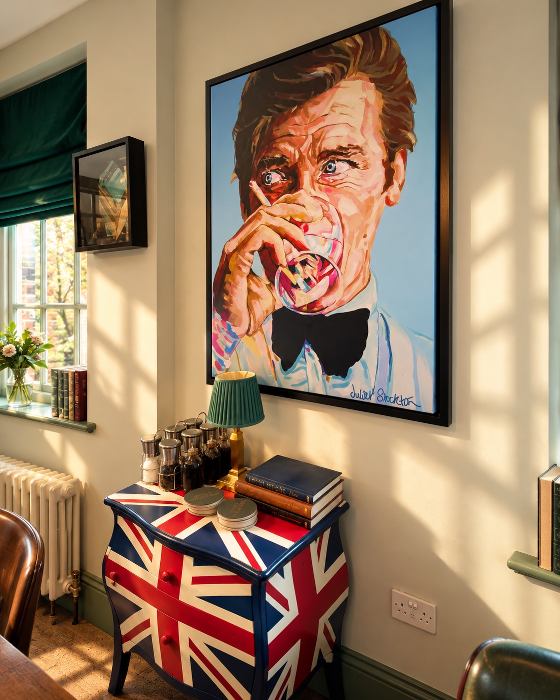 Portrait painting above a Union Jack cabinet