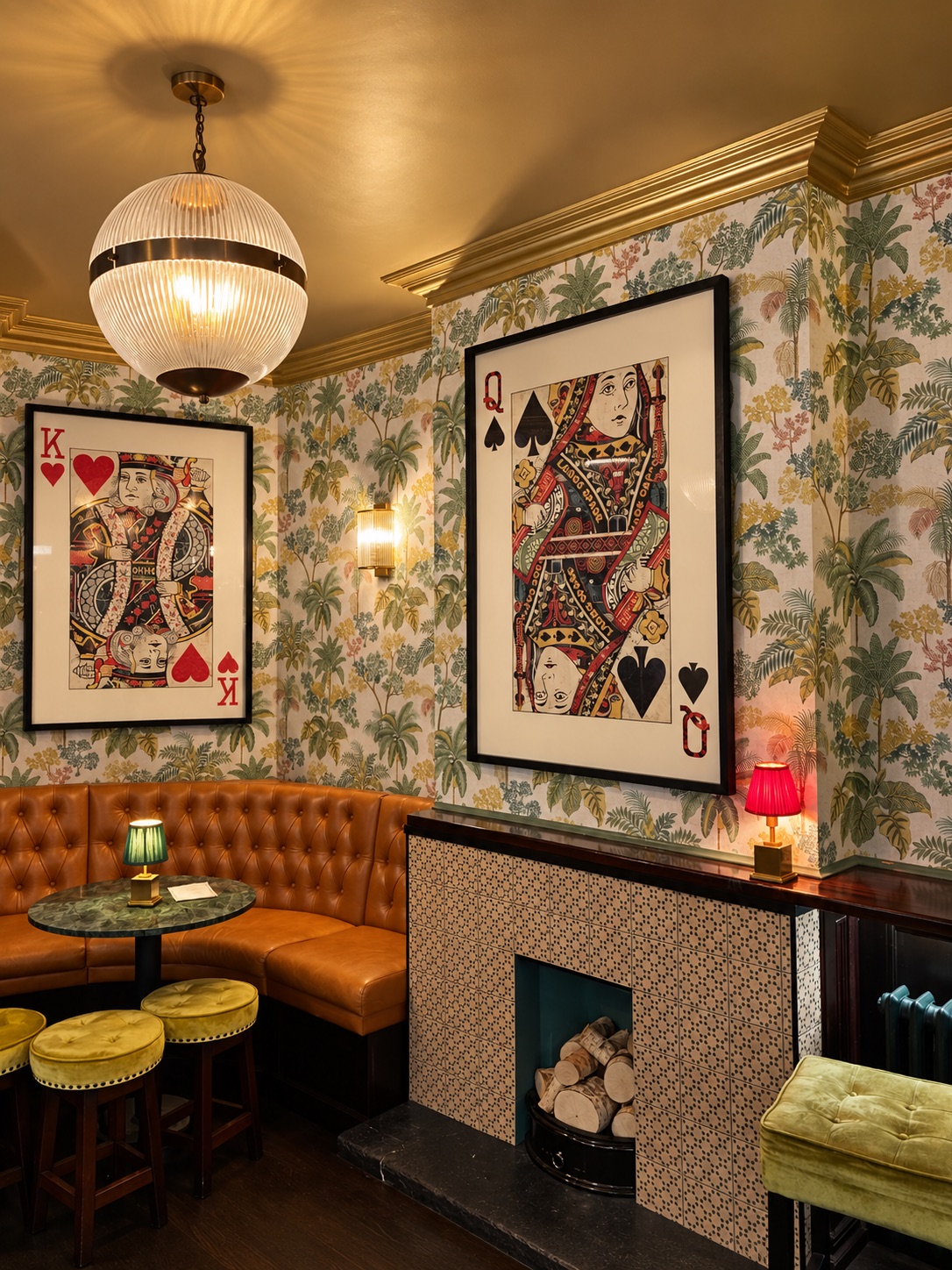 The lounge with palm wallpaper, globe pendant light and fireplace